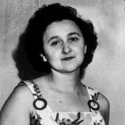 Ethel Rosenberg in her NYC residence. She wears a sleeveless, floral dress.